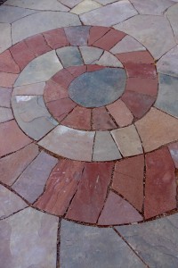 Different color flagstone used in a spiral pattern